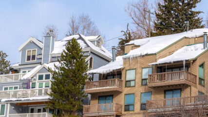 Panorama Mountain homes in Park City Utah with snow and icicles on roofs in winter