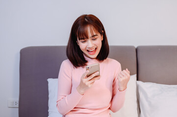 Asian woman online shopping at home. New normal lifestyle and Social Distancing.