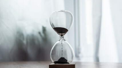 hourglass on the table, bottom center