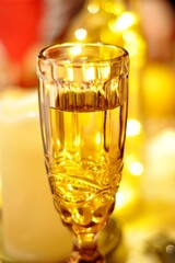 glass of champagne on golden background