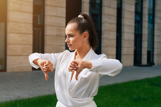 Sad Woman Manager Shows That Everything Is Bad. Thumbs Down. Stylish Lady Indicates Failure In Small Business