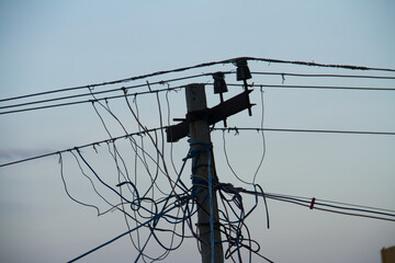 Electric pole clutter black wires clean sky