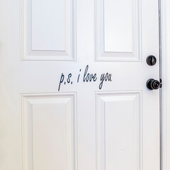 Square frame White interior wooden door in a blue wall