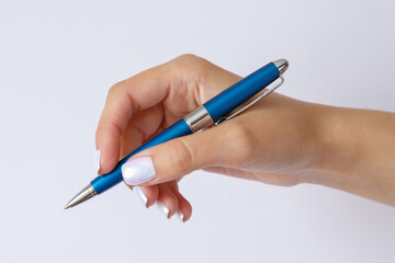 Gesture and sign, female hand holding a metal blue pen on a white background