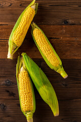 Corn cobs on wood background.