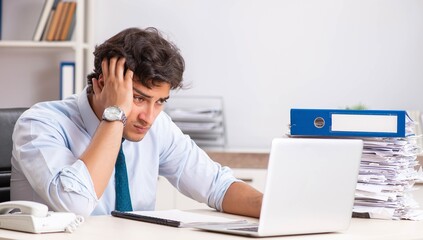Fototapeta na wymiar Overloaded busy employee with too much work and paperwork