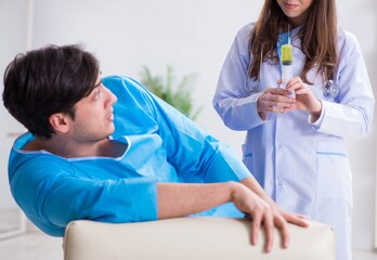 Fototapeta premium Funny man getting ready for buttocks syringe shot