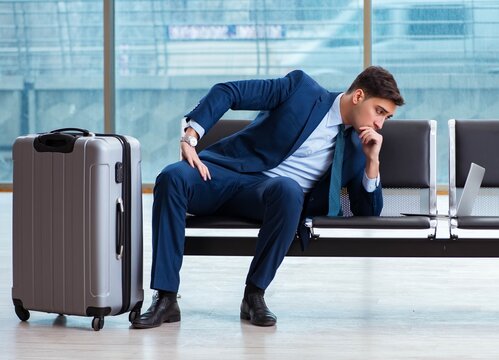 Businessman waiting at the airport for his plane in business cla