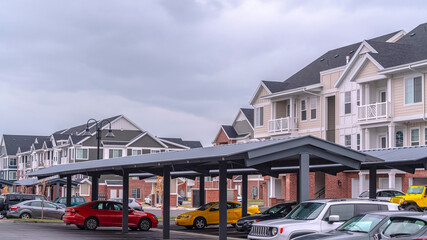 Panorama frame Undercover parking for cars at apartment complex © Jason