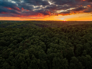 the setting sun over the forest hills