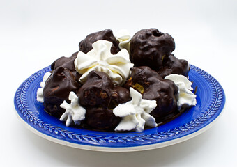 Profiterole isolated on white background. Sweet chocolate dessert