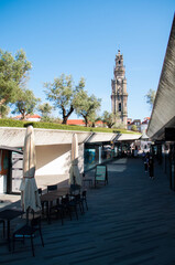 Street with cafes and shops, Green Square on the top, bell tower behind