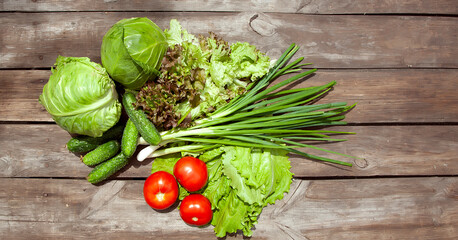 
Healthy eating Fresh farm vegetables tomatoes, cucumbers, salad lola rossaa and lola bianca, green onions, cabbage. Non-GMO Organic Vegetables, 100% Vegan Vegetarian Slimming Diet Wooden Background