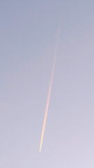 Vertical frame Contrail from an aircraft flying over the neighborhood of South Jordan City