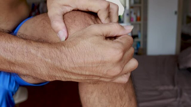 Close up man having knee pain and massage knee
