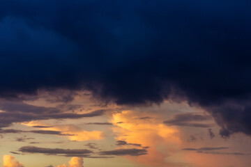 Romantic sunset sky with fluffy clouds