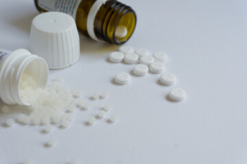 Homeopathy and pills over a white background. Medical concept.