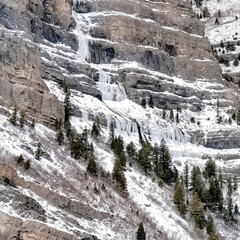 Fototapeta na wymiar Square Bridal Veil Falls in Provo Canyon with frozen water on steep slopes in winter