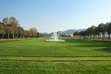 landscape of the Parc Borely Park with its palace, with a jet fountain, a water basin and a classical French lawn in front. Borely is a major park in the center of Marseille, France