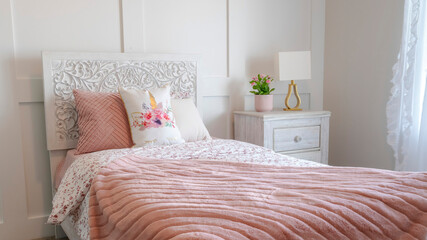 Panorama crop Bedroom interior with decorative headboard and feminine beddings on single bed