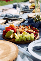 wooden platter with fruit and cheese