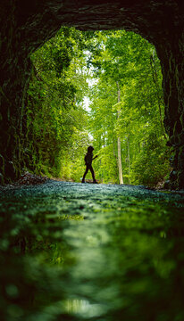 Little Girl Entering A Dark Cave For Adventure