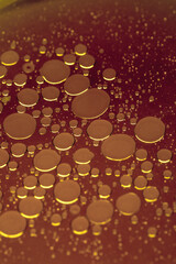 Oil bubbles on the surface of a red purple broth