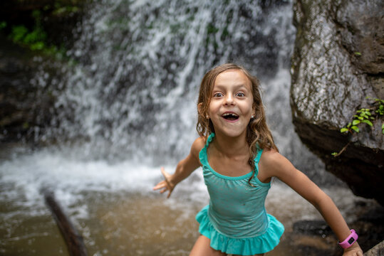Little Girl Swiming in a Cold Waterfall