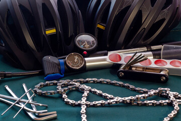 Bicycle accessories and tools in a dark key on a green background.