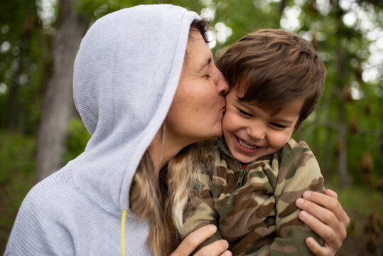 Mother kissing her young son