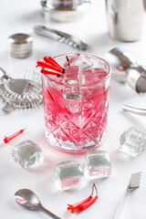 Cosmopolitan cocktail in a glass decorated with pink flowers