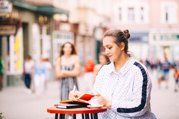 Woman doing work sitting in the street cafe
