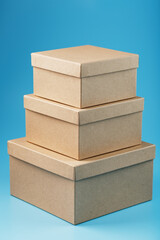 Cardboard boxes spread out on a blue background, free space.