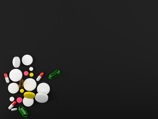 pills on the black background,vitamins and supplements on the black table