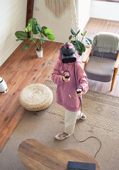 Hipster gamer teen girl pink hair wear vr headset goggles hold controllers play vr video game...