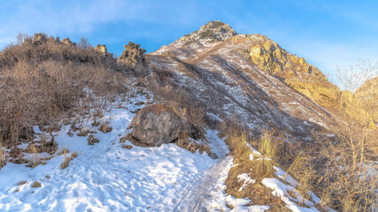 Fototapeta na wymiar Panorama crop Snowy terrain of a mountain in Provo Canyon on a sunny winter day in Utah