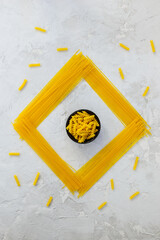 Corn pasta in a bowl on a gray table. Healthy food, gluten free. Horizontal orientation, top view.