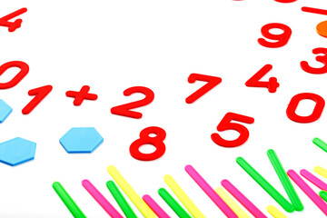 Multicolored plastic figures and numbers on a white background. Educational games for children. Math and calculation skills.