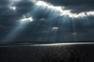 Rays of light shining through storm clouds.