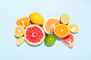 Mix of citrus fruits on blue background. Top view.