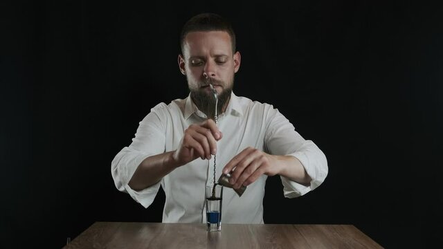 Preparing of Lexus Cocktail. Bartender pouring coffee liquor into a glass
