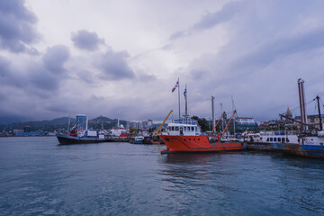 Port of Batumi. Clear turquoise water of the Black sea and ships. Tourist boats, pleasure boats.