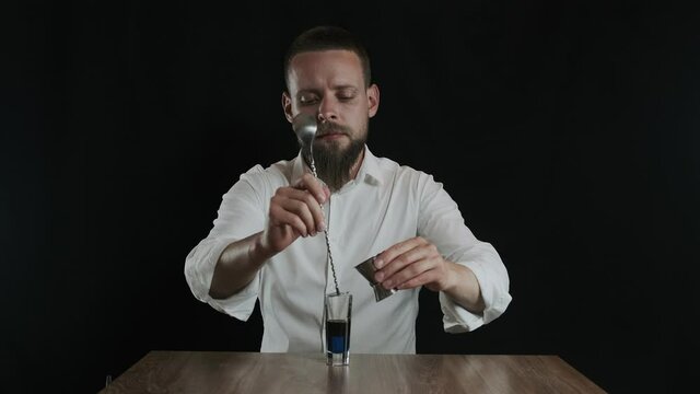 Preparing of Lexus Cocktail. Bartender pouring sambuca into a glass