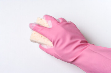 Hand in pink rubber glove is cleaning surface with sponge. Housekeeping and clean service concept.