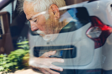 Senior man with Chest Pains Driving a Car.