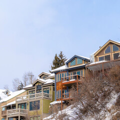 Square frame Homes with snowy roofs and balconies in scenic Park City Utah neighborhood