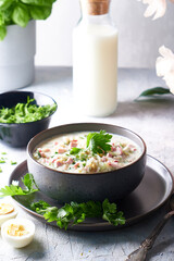 Traditional Russian cold okroshka soup served in a plate with herbs Kefir vegetable soup Vertical