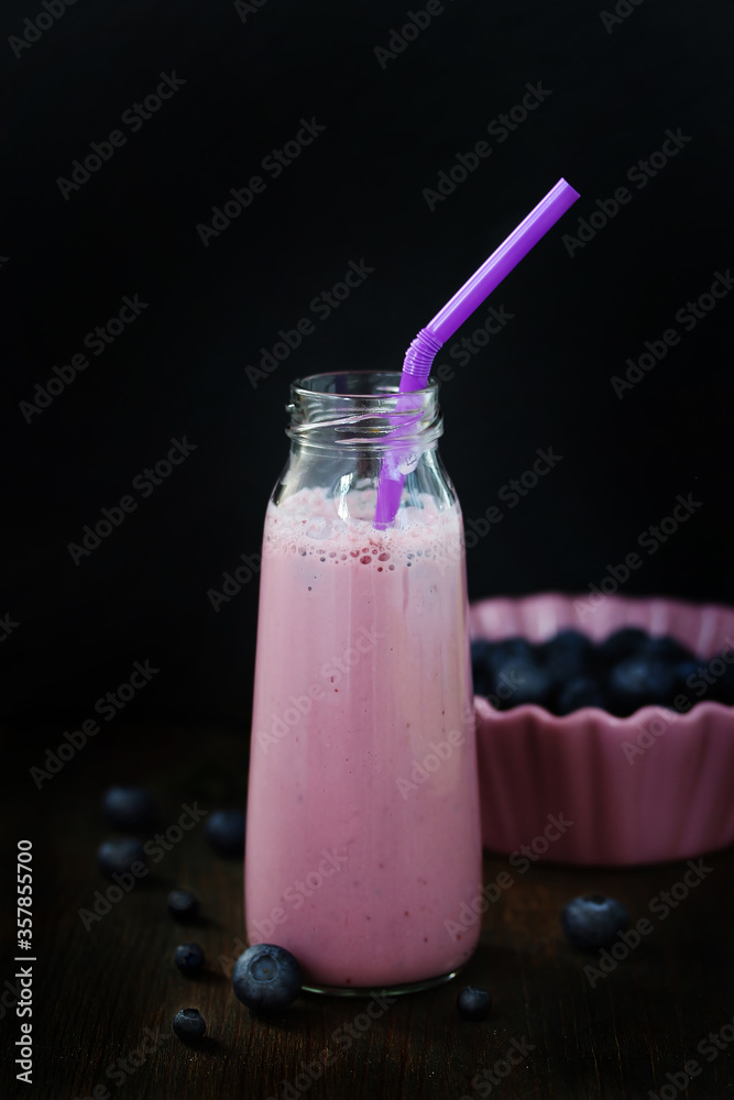 Sticker blueberry yogurt. Milkshake with blueberries in a bottle with a straw. 