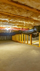 Vertical crop Basement or crawl space with upper floor insulation and wooden support beams