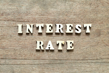 Alphabet letter block in word interest rate on wood background